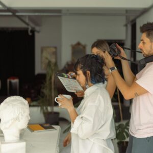 Creative photography session in İstanbul studio featuring sculptures and filming crew.