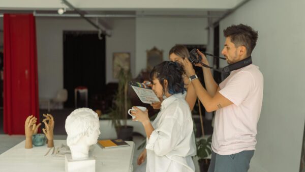 Creative photography session in İstanbul studio featuring sculptures and filming crew.